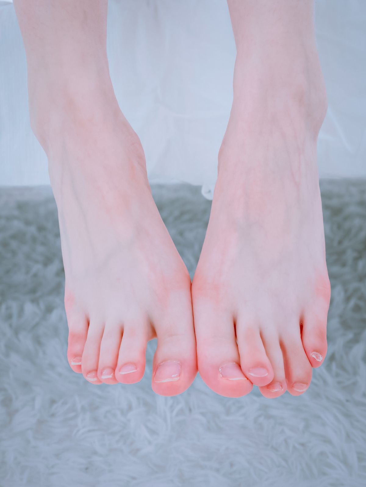 Close-up of bare feet resting gently, warm and relaxed
