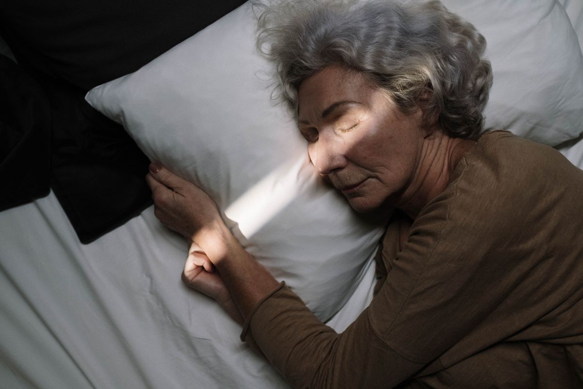 Older woman sleeping peacefully in bed