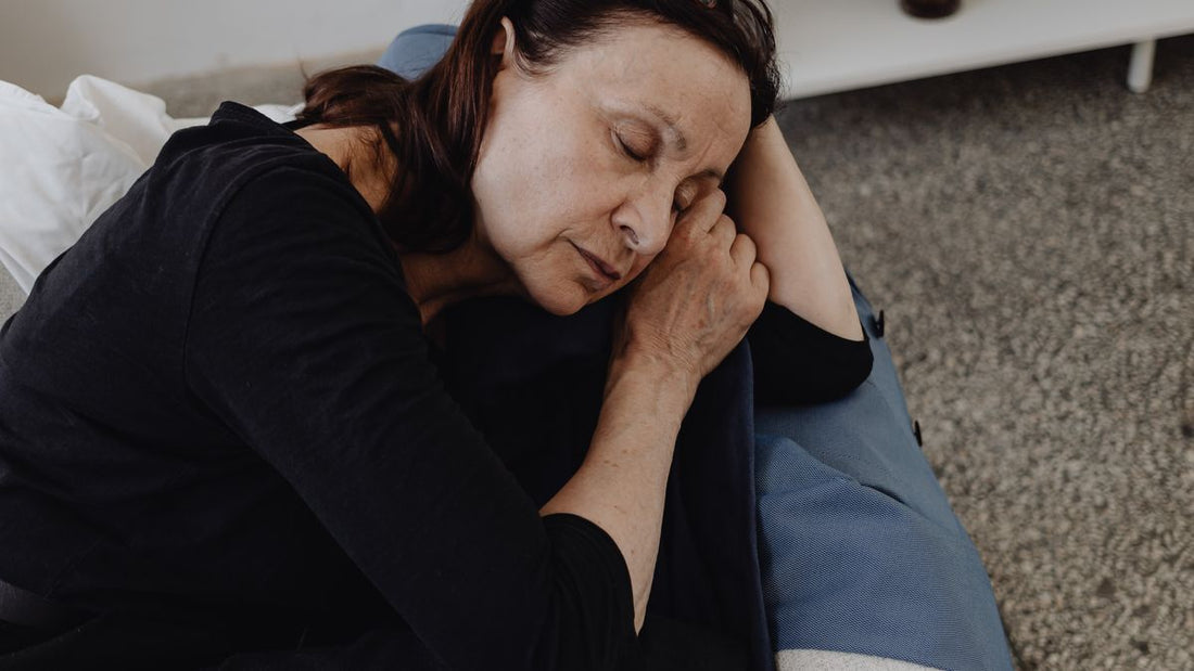 Older woman resting peacefully during an afternoon nap on the sofa