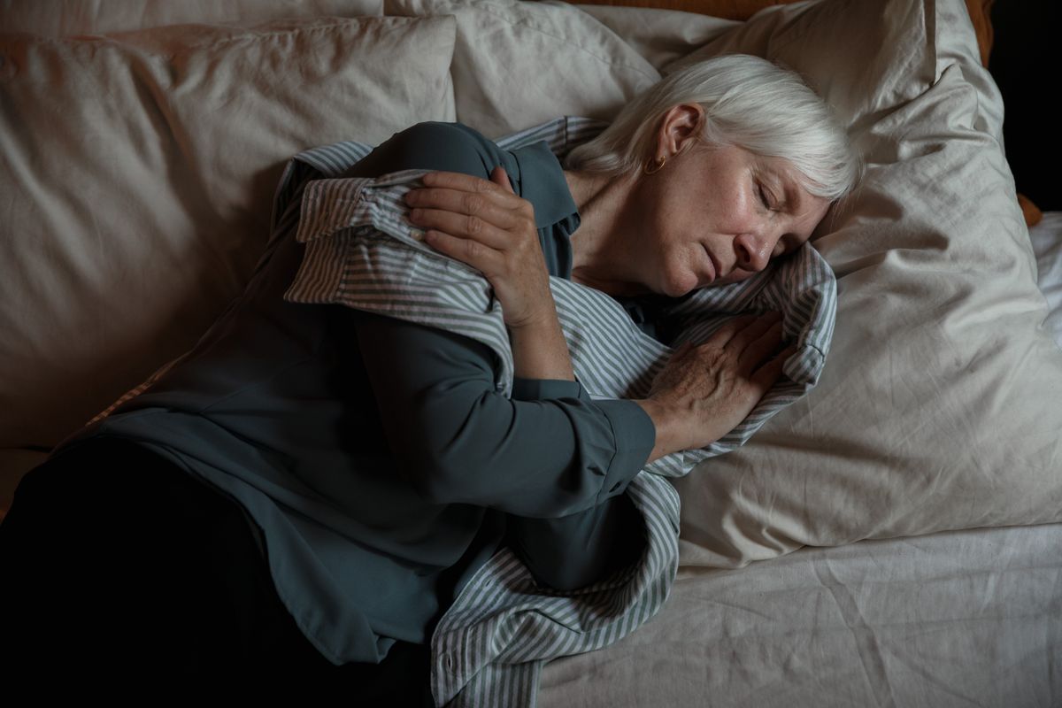 Senior woman resting peacefully in bed