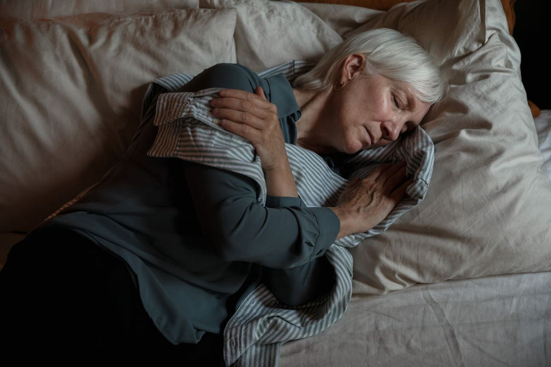 Senior woman sleeping peacefully in a cool, calm bedroom