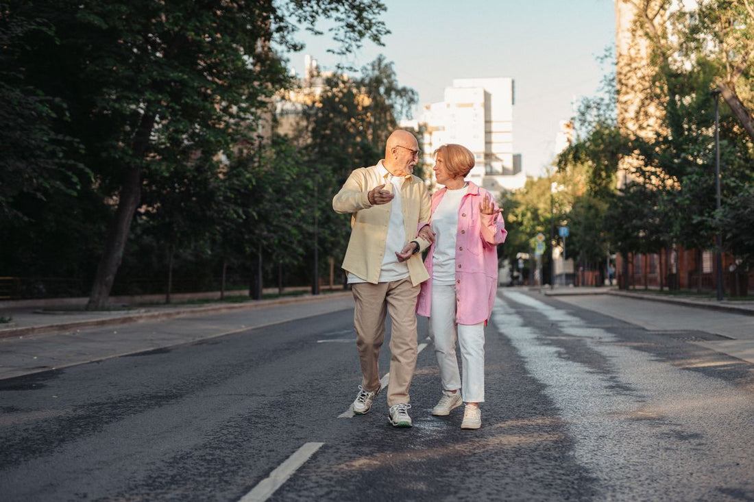 Happy couple over 55 walking together on a sunny street